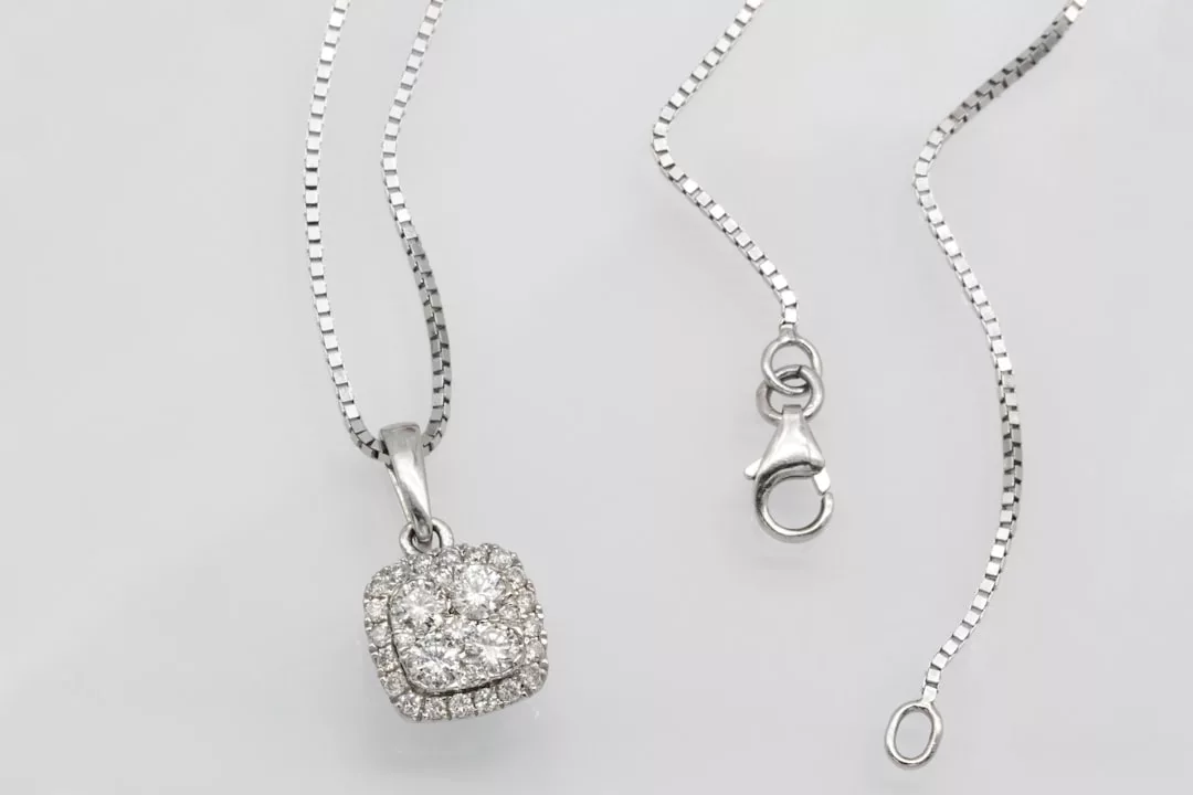 GLAMESiA-Halskette aus Silber mit quadratischem Diamantanhänger und Karabinerverschluss auf hellem Grund.