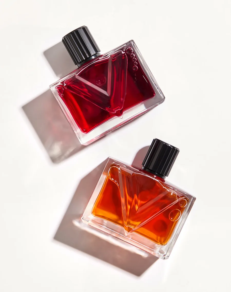 Valentino Vendetta: Flakon Vendetta Donna in Rot über dem Flakon Vendetta Uomo in Cognac auf hellem Grund